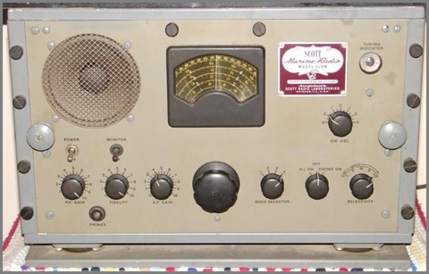 Gray tabletop receiver with large slide-rule dial and 7 knobs